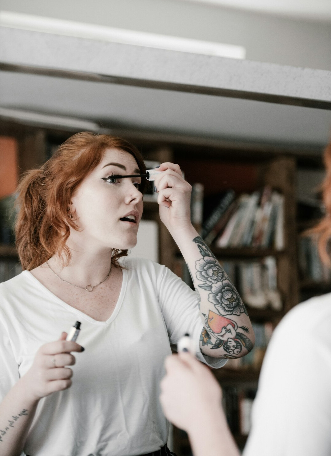 woman looking at makeup