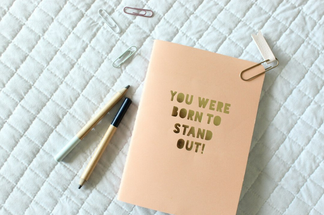 Notebook with handwritten notes and a pen
