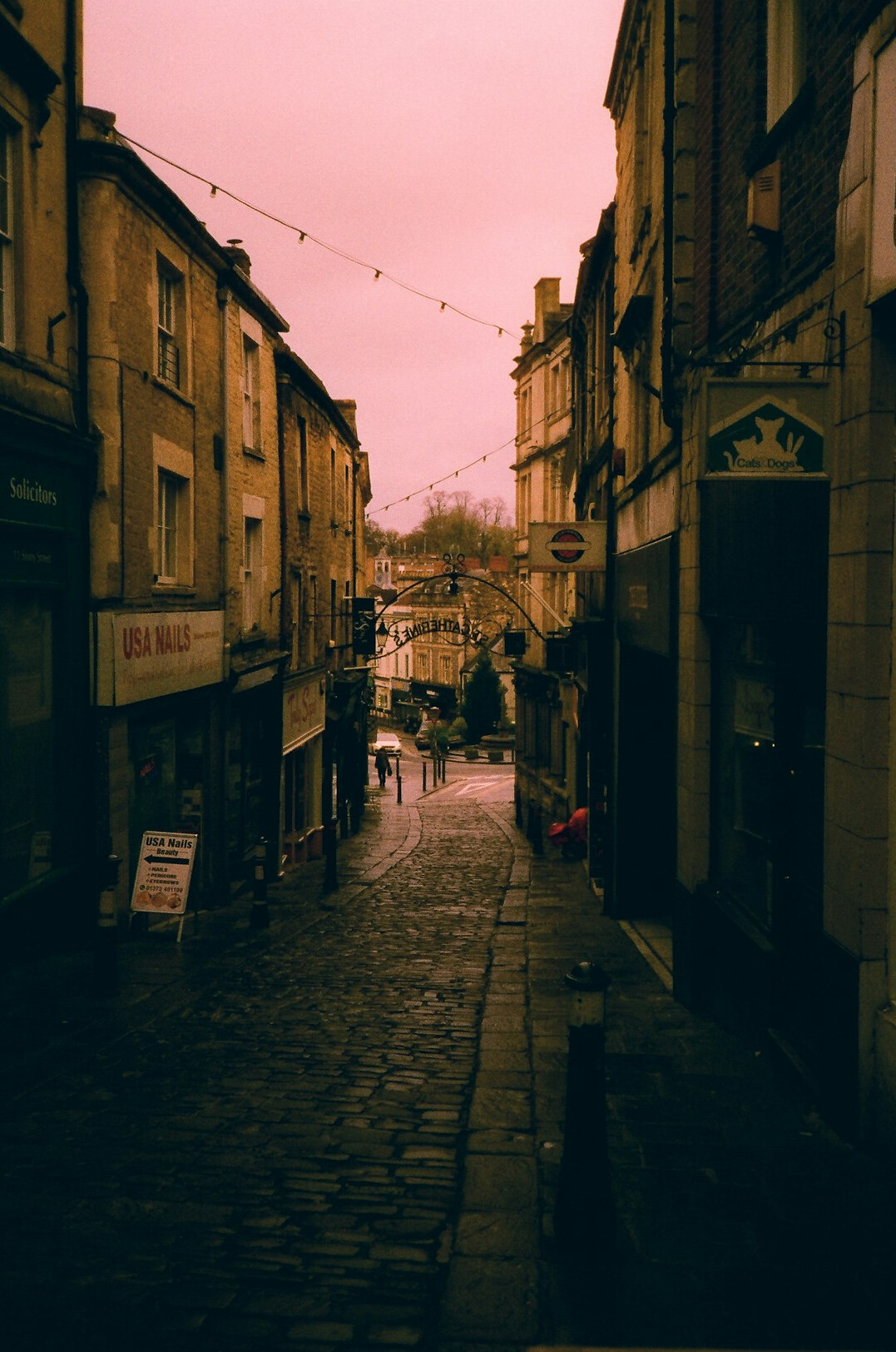 Atmospheric old city street at dusk with warm lights